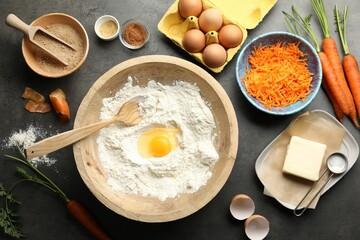 Wall Mural - Making carrot cake. Different ingredients for dough and kitchenware on dark textured table, flat lay