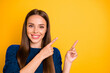 © deagreez - Close up photo of charming lady with long hairstyle pointing at copy space wearing maroon jumper isolated over yellow background