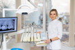 © Vadim - Dentist ready for procedure. A dental professional stands ready with equipment in a bright, modern clinic, showcasing her skills and technology.