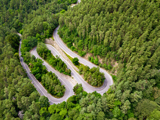 Fototapete - Aerial view of a road in the middle of the forest.