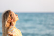 © Sunny studio - Young happy woman enjoying by sunrise against blue sea and sky on summer vacation