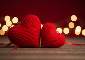 Wall Mural - Two cozy red heart decorations sit together, symbolizing love and friendship, perfect for Valentine's Day or romantic settings.