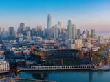 San Francisco skyline at sunrise, featuring Oracle Park, a baseball stadium. Elevated view of the city and waterfront. San Francisco, California, USA