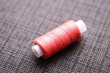 Poster - Thread spool on a table, perfect for sewing and crafting.