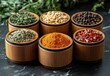 © ANUAR - Colorful assortment of spices in bamboo containers arranged on a dark marble surface, highlighting culinary diversity and aromatic flavors for food enthusiasts