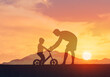 © kieferpix - Father teaching child to ride a bicycle, parenting, child development