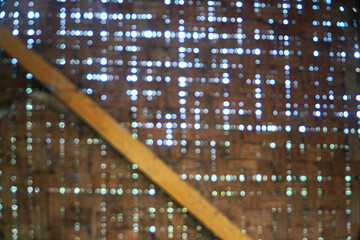 Poster - Blurred image of sunlight through a weathered wooden barn ceiling. Abstract Bokeh: Light Through Barn Wood