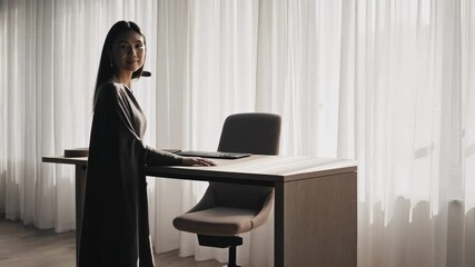 Aufkleber - Confident businesswoman standing near sleek desk in contemporary workspace, radiating professional energy and leadership potential with warm smile and engaging presence