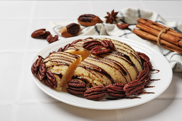 Wall Mural - Delicious sweet semolina halva with pecans on white tiled table, closeup