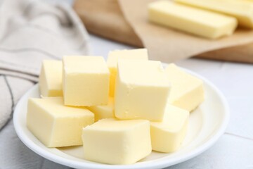 Wall Mural - Pieces of fresh butter on white textured table, closeup