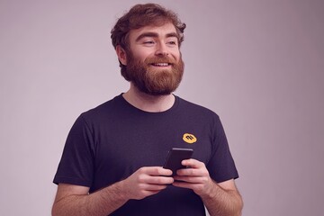 Happy man using phone, studio shot, casual