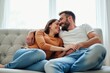 © SimpleDesignStudio - A Romantic Evening: A Young Caucasian Couple Embracing and Smiling Together on a Cozy Sofa in a Brightly Lit Living Room, Sharing Intimate Moments of Affection