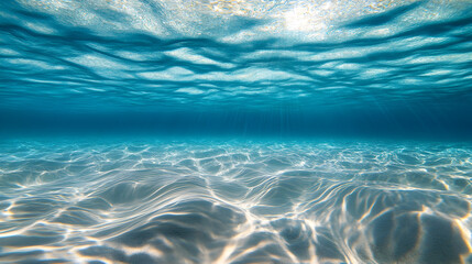 created by light bending through clear tropical water, casting fluid shadows on the ocean floor 