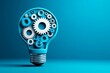 © panpatsa - A creative representation of a light bulb integrated with gears.