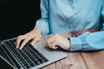 Poster - Woman Working on Laptop with Striped Shirt in Modern Workspace, Business concept