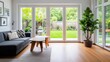 © evgenia_lo - A spacious living room showcases a modern sofa and wooden table, offering a clear view of a vibrant green garden through large glass doors