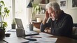© Velem - Retirement financial stress in a stylish home office. Featuring concern and contemplation