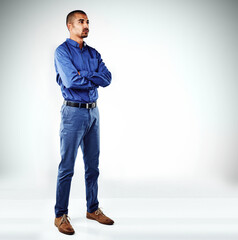 Poster - Arms crossed, serious and thinking with business man in studio for ambition, inspiration or opportunity. Idea, mission and space with confident employee on white background for career development
