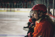 © Cavan - A young female ice hockey player sitting on the bench