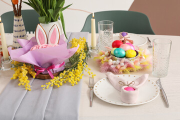 Wall Mural - Beautiful Easter table setting with flowers, candles and painted eggs