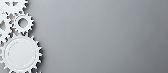 White gears arranged on a grey background with ample copy space on the right side, viewed from the top, ideal for business concepts.