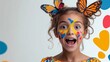 © Trushchenko_O - Young girl with colorful face paint and butterfly wings on her head. She is smiling and looking at the camera