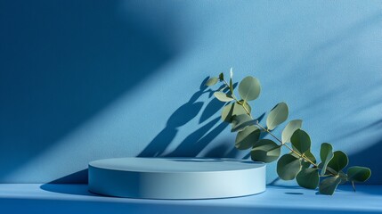 Poster - Elegant Display Featuring a Round Pedestal and Eucalyptus Leaves Against a Soft Blue Background Creating Calm Aesthetic Vibes