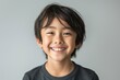 © imagemir - Smiling Asian boy with short black hair, showcasing joy and innocence against a neutral background.
