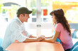 © peopleimages.com - Happy, couple and holding hands in restaurant, date and people with commitment, smile or romance. Lunch, man and care for woman, bonding or conversation for relationship status, love or talk in diner