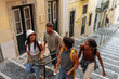 © bernardbodo - Group of tourists walking down stairs in lisbon, portugal