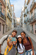 © bernardbodo - Group of happy tourists taking a photo of themselves in lisbon, portugal