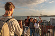 © bernardbodo - Tourist taking photo of friends enjoying panoramic view of lisbon