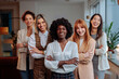© bernardbodo - Cheerful businesswoman posing in front of her colleagues