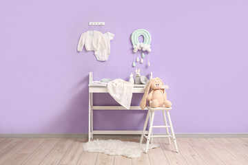 Wall Mural - Interior of children's room with changing table, toys and baby clothes