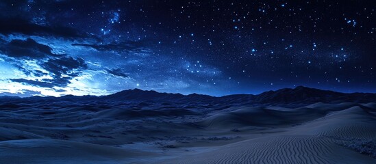 Wall Mural - Desert landscape featuring rolling hills and dunes illuminated by a starry night sky with blue tones and subtle cloud patterns in the atmosphere.