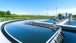 © WACHI - A modern water treatment facility featuring circular tanks with clear water, surrounded by greenery under a bright blue sky.