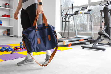 Wall Mural - Sporty woman with bag at gym