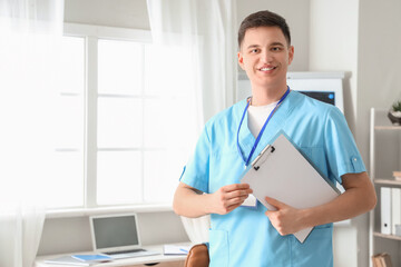 Poster - Male medical intern with clipboard in office