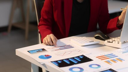 Wall Mural - Businesswoman analyzing financial data on a desk.