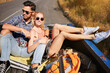 © Beak Joint/peopleimages.com - Relax, journey and happy couple on road trip for holiday, vacation and outdoor for relationship. Man, woman and transport for tourism, travel and adventure together for love in back of pickup truck