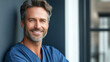 © milo - Male medical professional in scrubs, compassionate expression, 3/4 view against modern clinic wall, gentle window light with soft fill, f/2.8, heal
