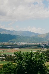 Canvas Print - Scenic valley with mountains under a cloudy sky