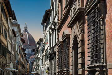 the narrow street that leads directly to the beautiful cathedral santa maria del fiore in florence i
