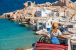 © ADDICTIVE STOCK - Woman observing the scenic view of Firopotamos, Milos, Greece