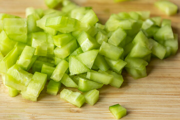 Wall Mural -  chop fresh cucumber on a wooden cutting board close-up