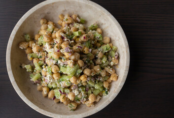 Wall Mural - delicious healthy salad with chickpeas, cucumber, and feta cheese close-up