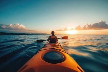 Wall Mural - A person paddles a kayak in the calm ocean during sunset, great for travel or outdoor adventure scenes