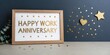 © Wan - A framed message celebrates a work anniversary, surrounded by golden stars and hearts, conveying joy and recognition in a festive atmosphere.