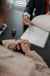 © kamiphotos - a car salesperson is explaining the details of a car purchase contract to the buyer before signing the sales contract, showroom, dealer, car contract, sining a car purchase contract