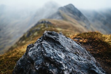 Poster - A large rock sits atop a lush green hillside
